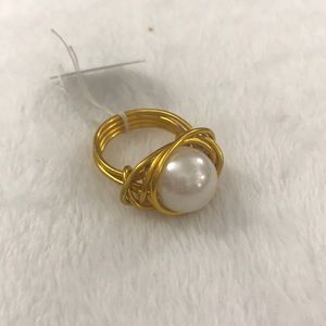 Gold wired ring with large white bead on inside